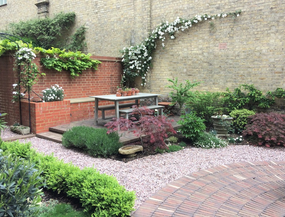 Photo of a medium sized courtyard formal partial sun garden in Sussex with brick paving.