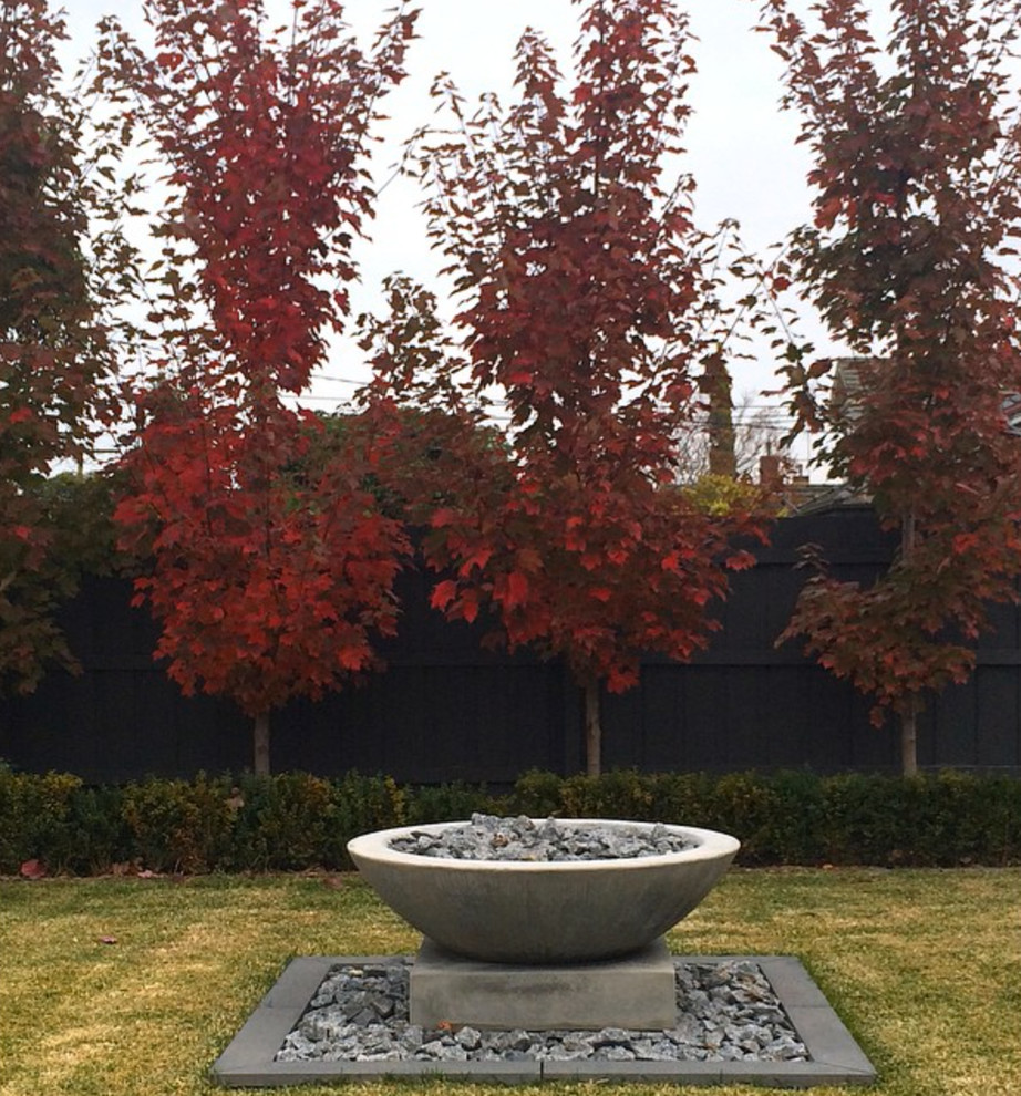 Photo of a large traditional partial sun front yard stone formal garden in Melbourne for fall.