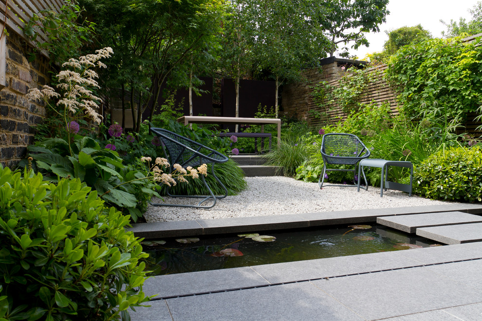 Design ideas for a contemporary garden in London with a water feature.