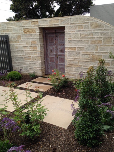 Photo of a medium sized traditional front formal full sun garden for spring in Adelaide with concrete paving.