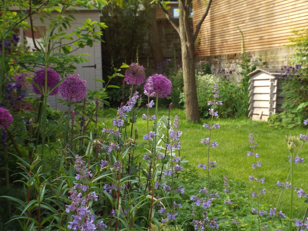 Diseño de jardín de estilo de casa de campo en patio trasero con exposición parcial al sol