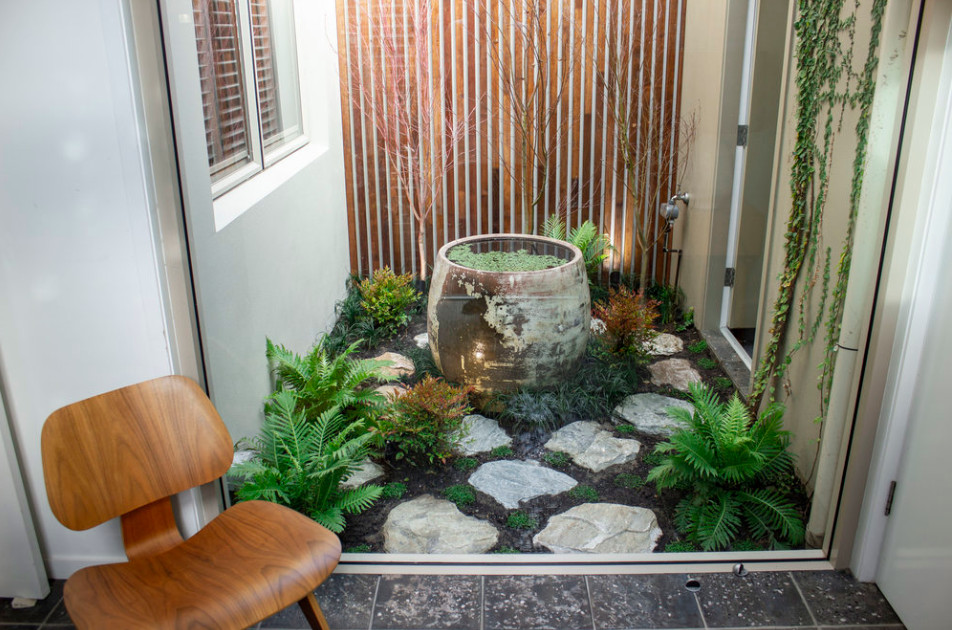 Inspiration for a small contemporary partial sun courtyard stone and wood fence landscaping in Central Coast for fall.