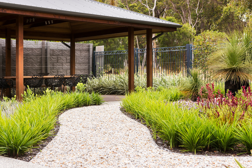 Photo of a large contemporary full sun backyard concrete paver formal garden in Perth.