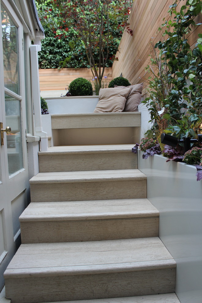 This is an example of a small contemporary partial sun backyard landscaping in London with decking.