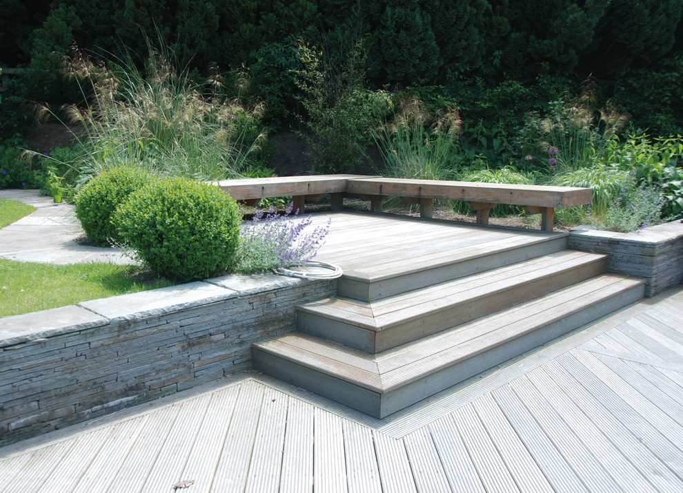 This is an example of a large contemporary full sun backyard landscaping in Dublin with decking for summer.