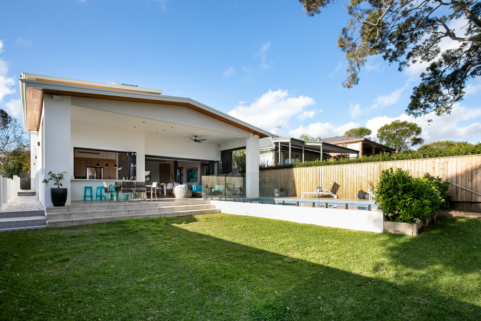 Inspiration for a large contemporary partial sun backyard brick formal garden in Sydney for spring.