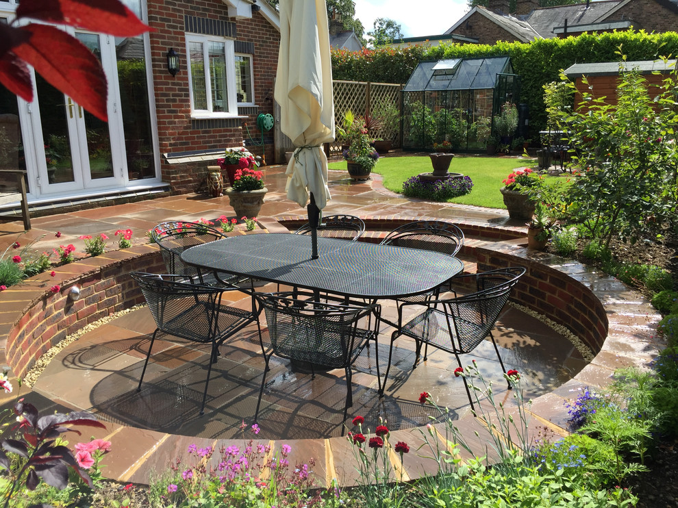 Photo of a medium sized classic back garden in Surrey with natural stone paving.