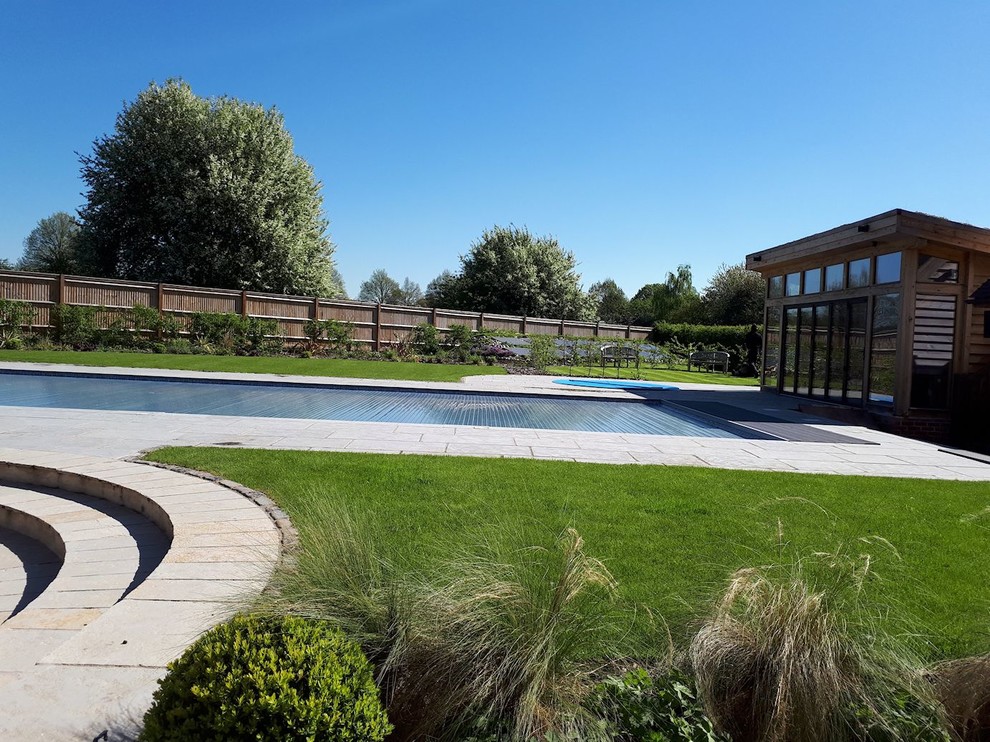 Inspiration for a large contemporary back full sun garden for summer in Buckinghamshire with natural stone paving.