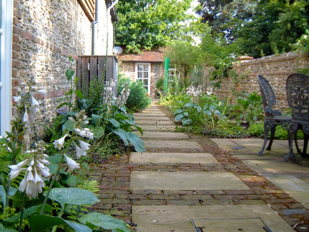 Farmhouse garden in Sussex with a water feature.