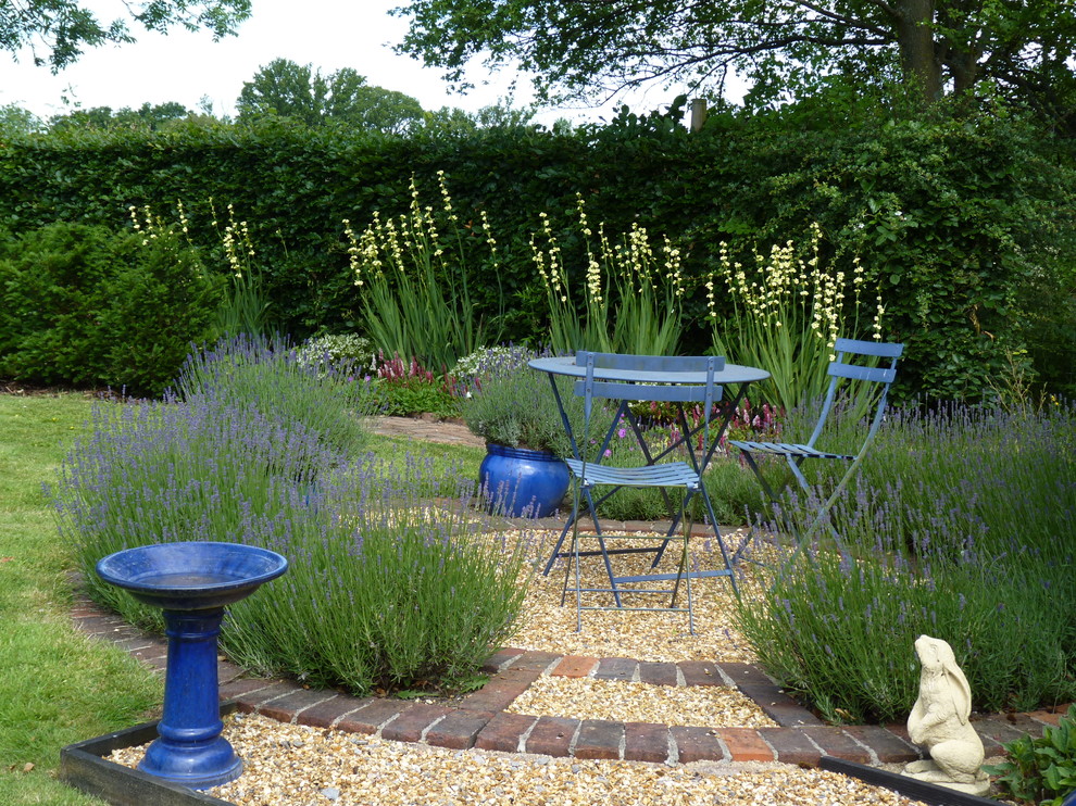 Photo of a large farmhouse partial sun backyard landscaping in Hertfordshire.