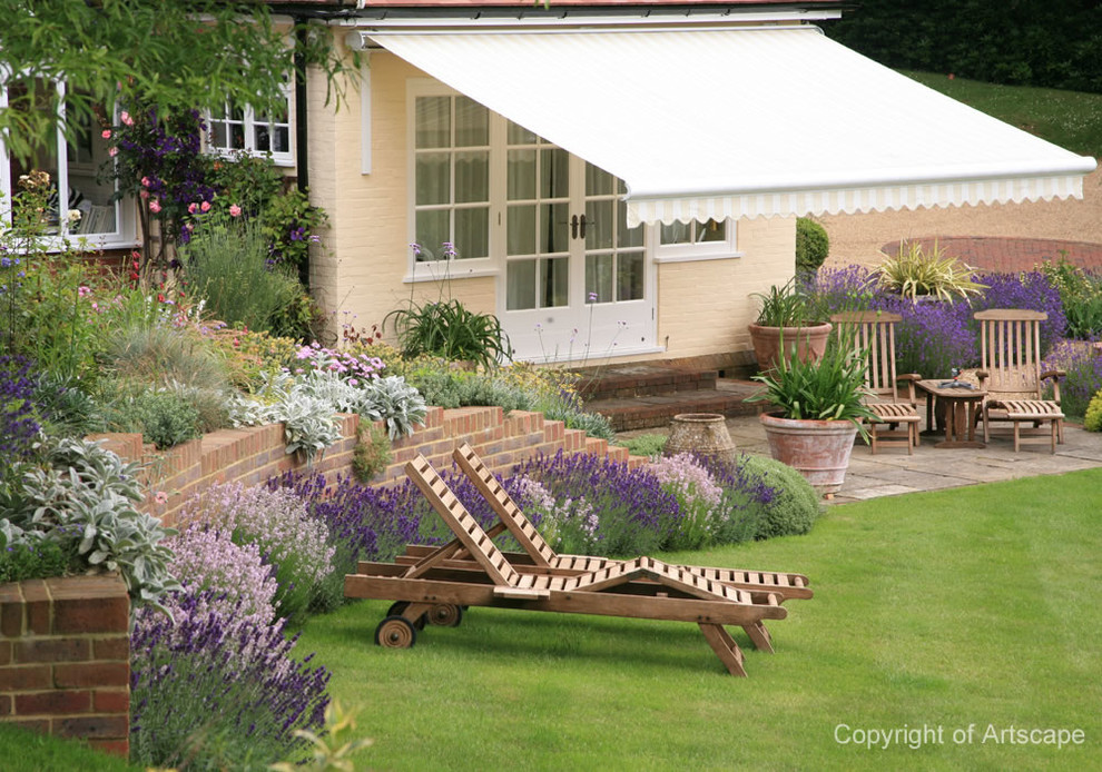 Design ideas for a large traditional back full sun garden in Berkshire with natural stone paving.