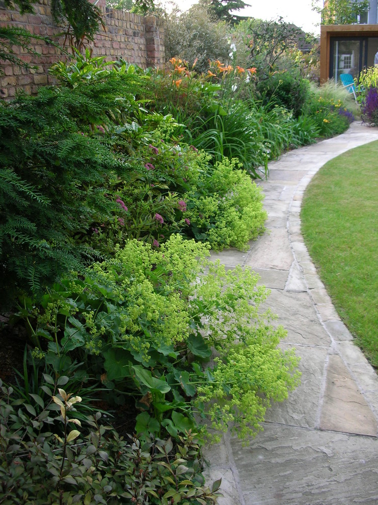 Design ideas for a contemporary garden for summer in London with natural stone paving.