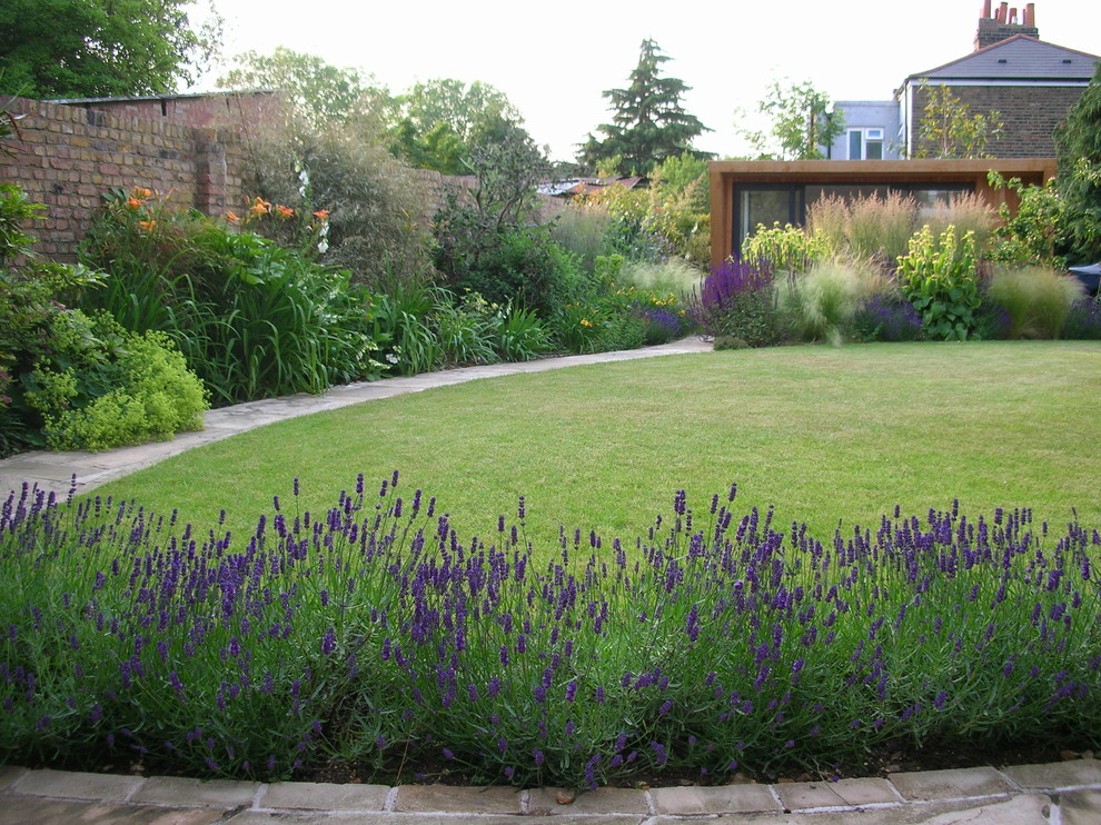 Contemporary garden for summer in London with natural stone paving.