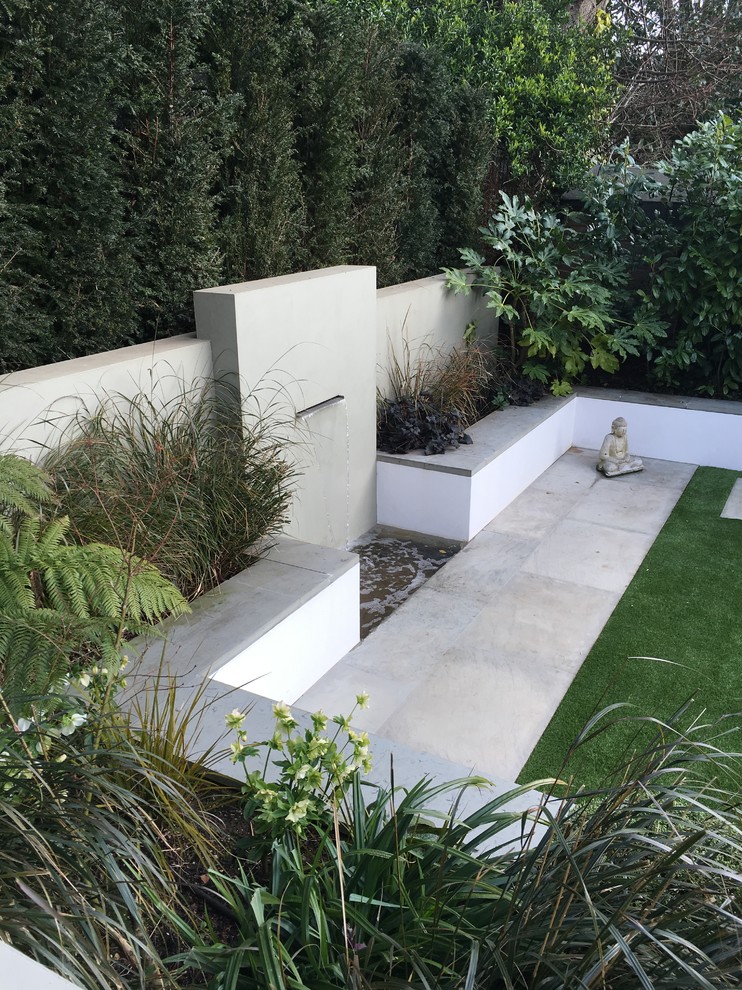 Photo of a contemporary formal garden in Essex with a water feature.