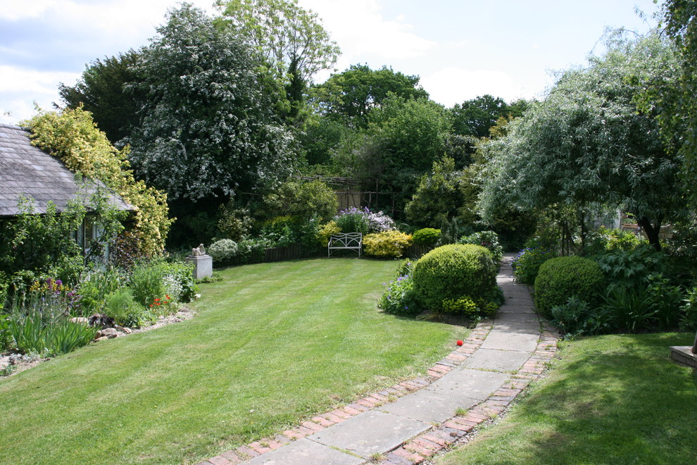 Photo of a medium sized eclectic back full sun garden for spring in Sussex.