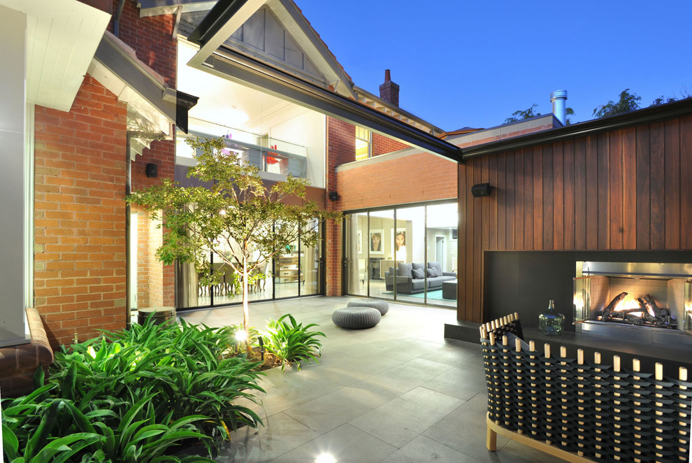 Photo of a contemporary back garden in Melbourne with an outdoor sport court and natural stone paving.