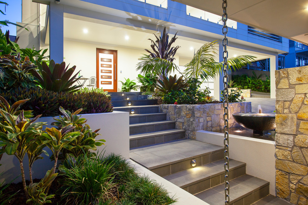 Photo of a mid-sized contemporary front yard stone garden path in Brisbane.