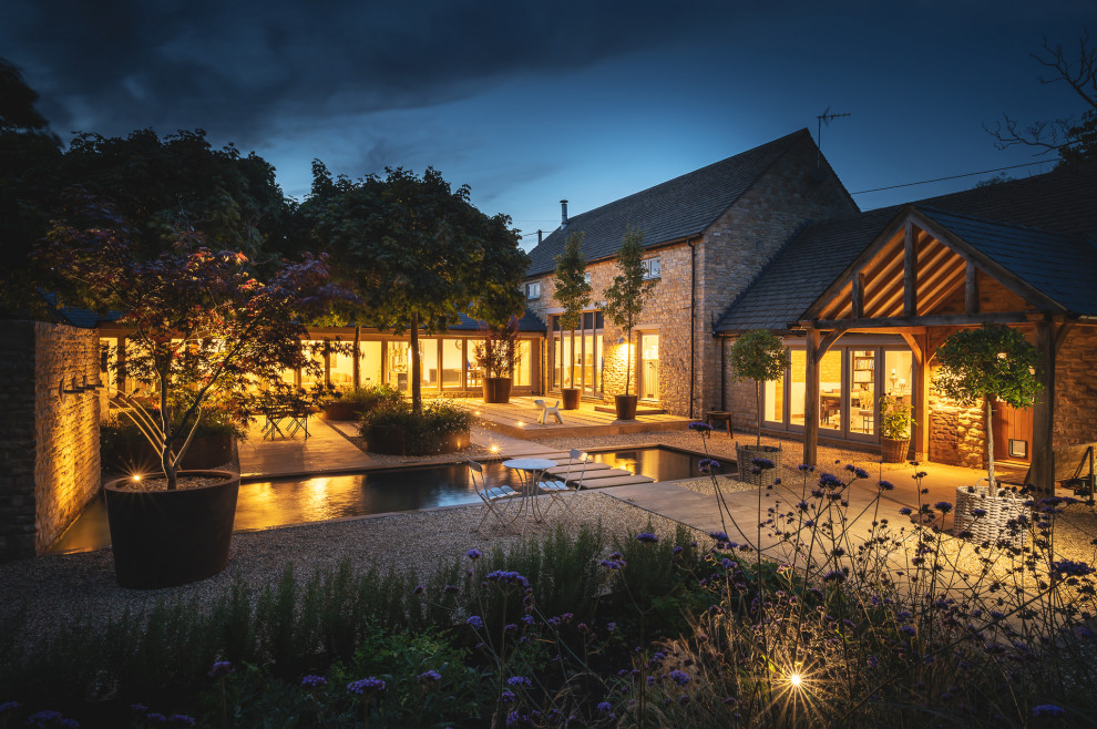 Inspiration for a small contemporary courtyard formal full sun garden for spring in Oxfordshire with a waterfall.
