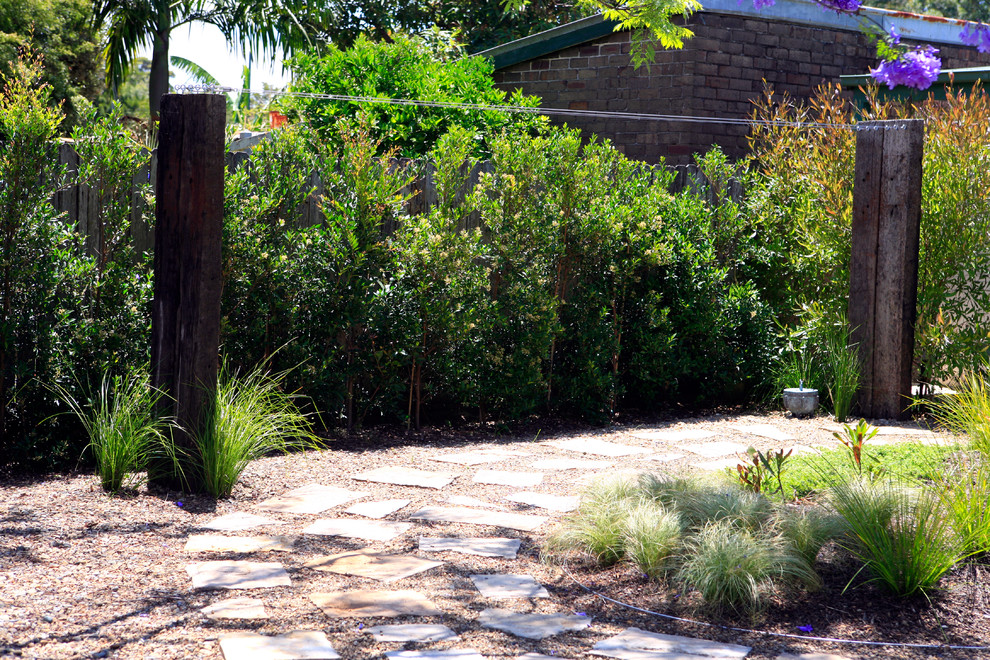 Design ideas for a rustic back xeriscape full sun garden in Sydney with gravel.