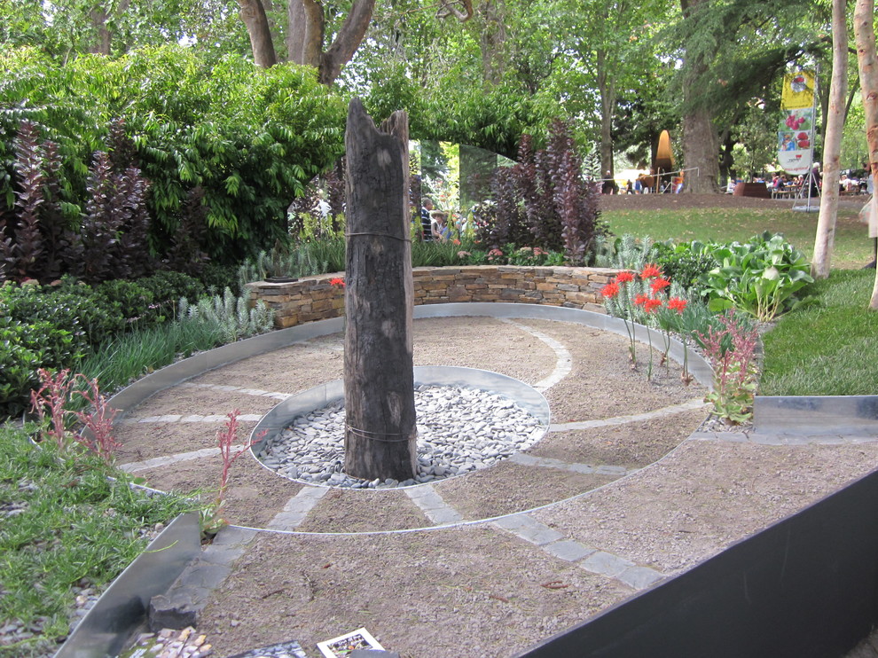 Cette image montre un petit jardin bohème avec une exposition partiellement ombragée et du gravier.
