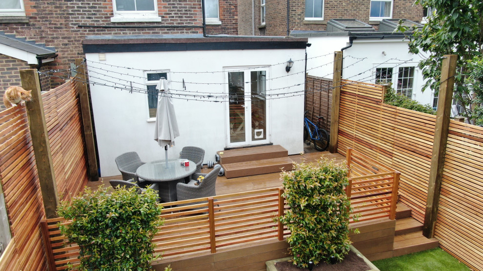 This is an example of a medium sized contemporary back garden in Surrey.