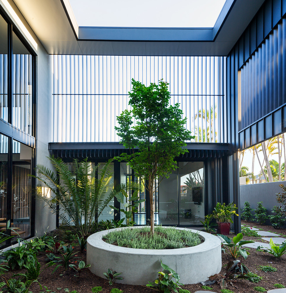 Idée de décoration pour un jardin sur cour design avec une exposition partiellement ombragée.