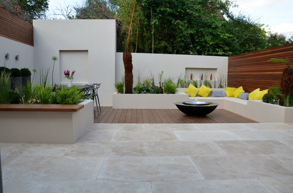 This is an example of a small contemporary back patio in London.