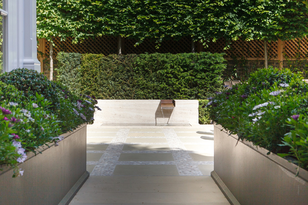Photo of a small contemporary full sun courtyard stone landscaping in London for summer.
