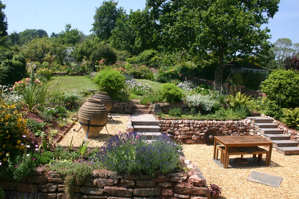Design ideas for a large farmhouse full sun backyard gravel landscaping in Devon.