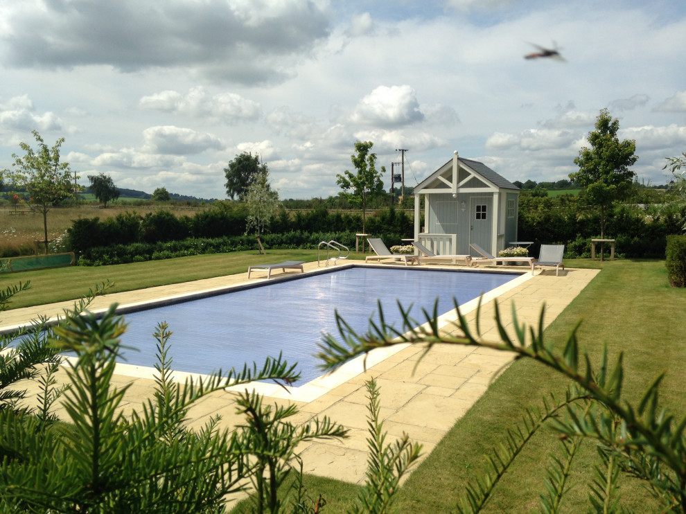 Photo of an expansive traditional garden in Gloucestershire with decorative stones.