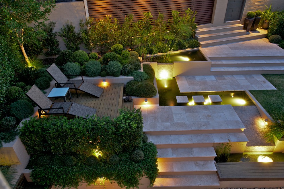 Photo of a large contemporary garden in Sydney with a water feature.