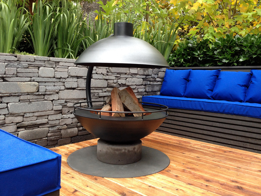 Medium sized contemporary back formal garden in Melbourne with a fire feature.