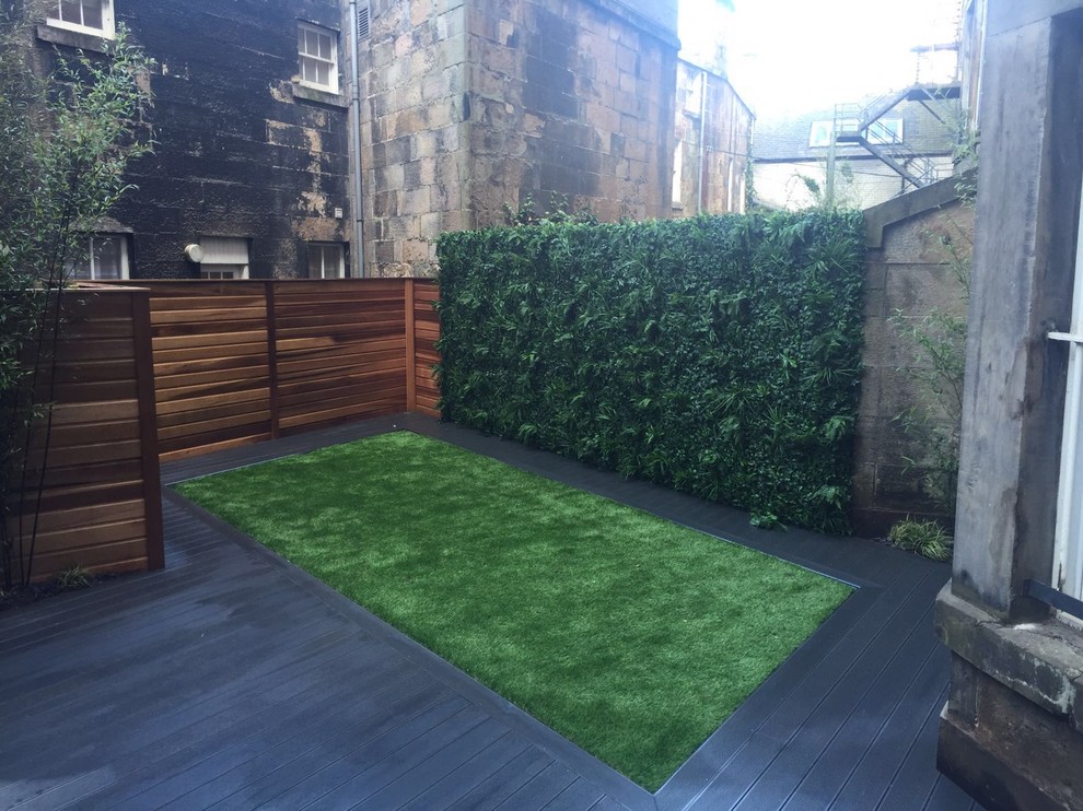 Inspiration for a small contemporary back partial sun garden for summer in Glasgow with a living wall and decking.