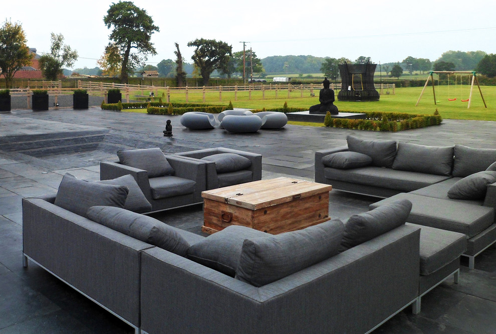 Inspiration for an expansive contemporary back full sun garden in West Midlands with natural stone paving.
