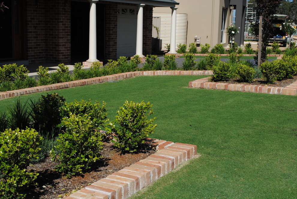 Inspiration for a mid-sized modern full sun front yard brick landscaping in Sydney for summer.