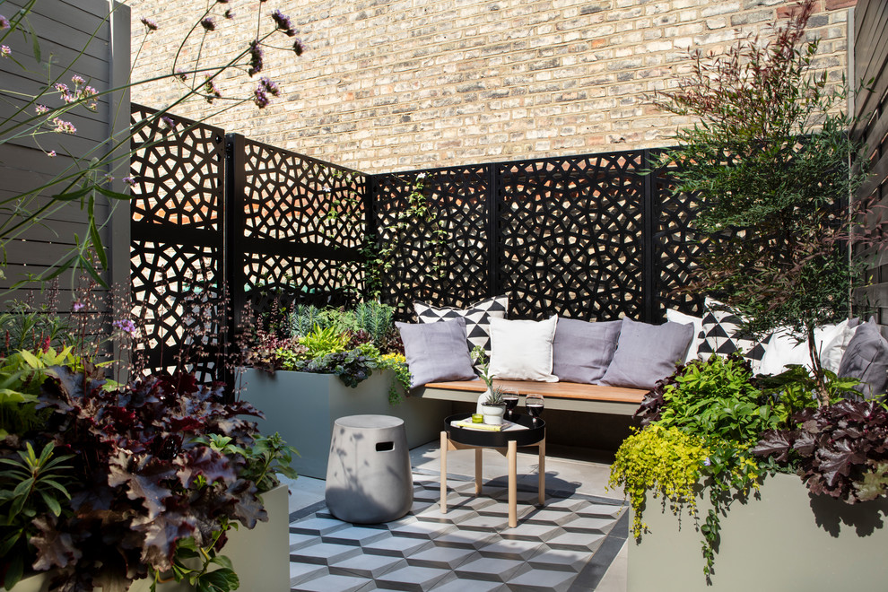 Small contemporary garden in London with a potted garden.