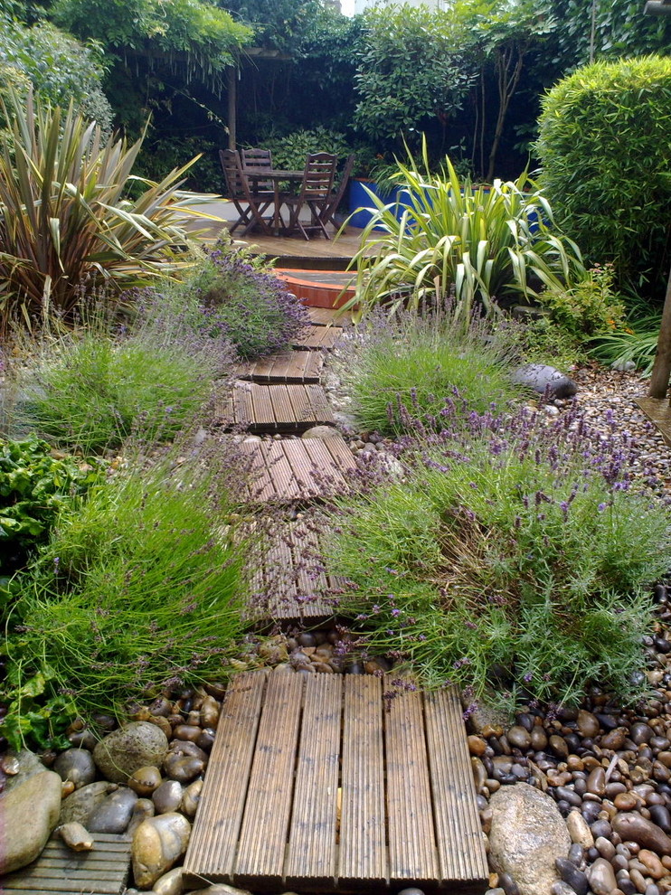 This is an example of a contemporary garden in Other with a retaining wall and brick paving.