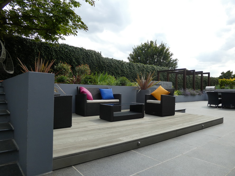 This is an example of a large contemporary back garden in Cheshire.