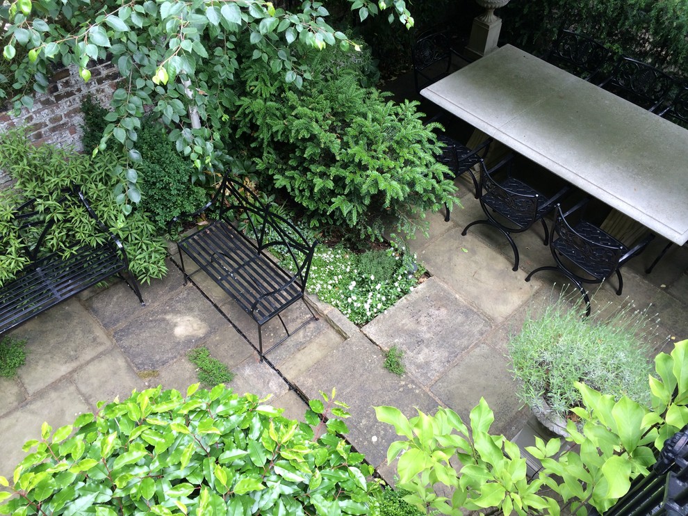 Photo of a small traditional back formal garden in London with a garden path and natural stone paving.