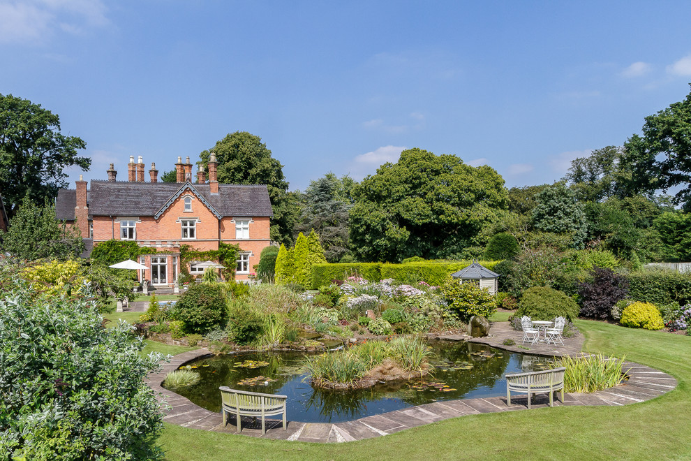 Inspiration for a traditional back full sun garden in Cheshire with a pond.