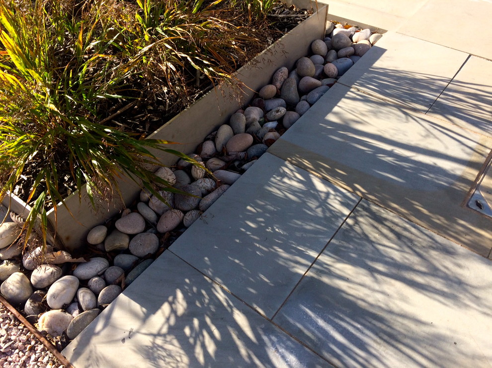 Inspiration for a contemporary full sun garden in Devon with natural stone paving.