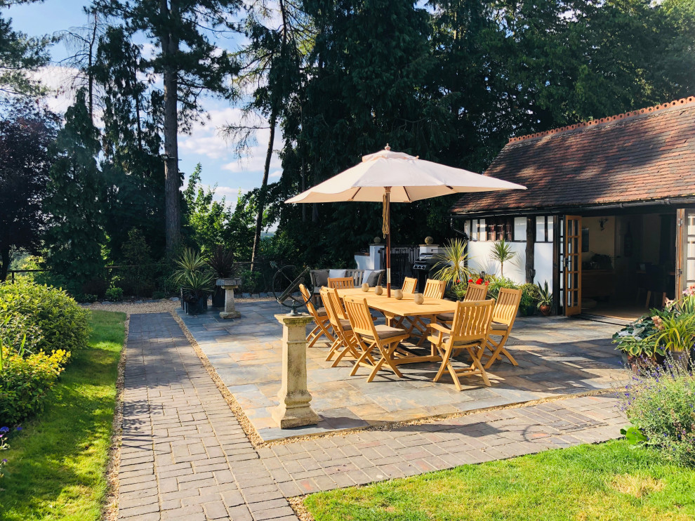 Photo of a large country garden in West Midlands with natural stone paving.