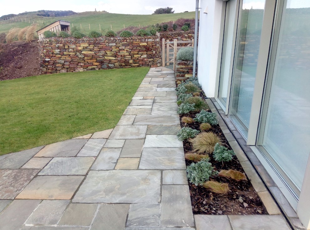 Inspiration for a medium sized scandi side garden in Cornwall with a garden path and natural stone paving.