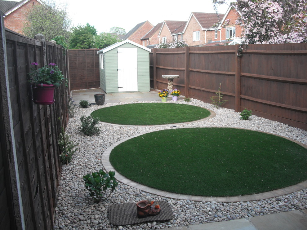 Immagine di un piccolo giardino design esposto a mezz'ombra dietro casa con pedane