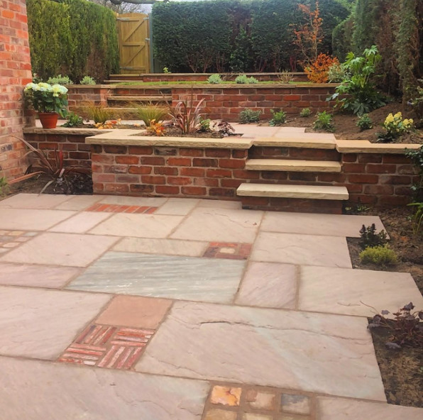 Photo of a medium sized traditional back formal garden in Other with a garden path and natural stone paving.