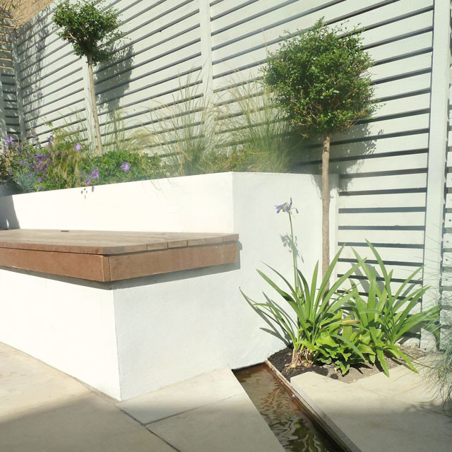 Design ideas for a small contemporary backyard water fountain landscape in London.
