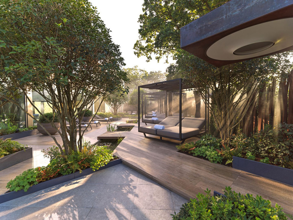 Foto di un grande giardino design esposto in pieno sole nel cortile laterale in primavera con pavimentazioni in pietra naturale