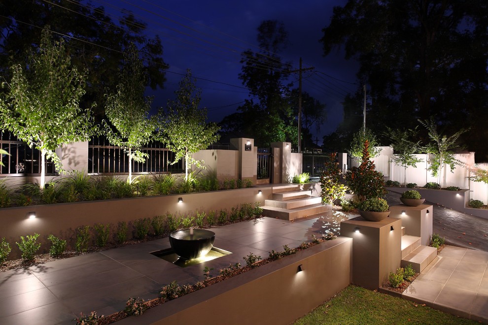 Design ideas for a large contemporary partial sun front yard stone landscaping in Sydney for winter.
