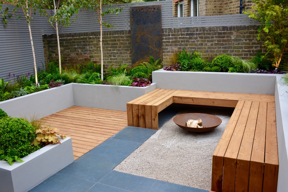 Small contemporary back partial sun garden in London.