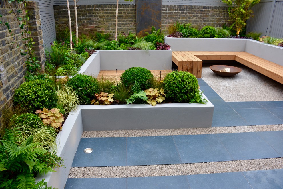 This is an example of a small contemporary back partial sun garden in London.